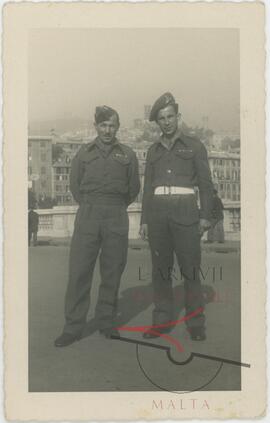 Two men wearing RMAA uniforms, somewhere abroad