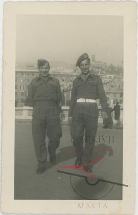 Two men wearing RMAA uniforms, somewhere abroad