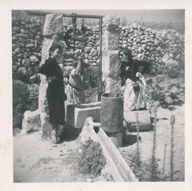 The Pizzuto sisters standing beside a well