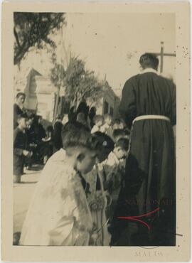 Altar boys paying respect to the passing procession