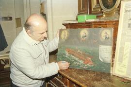 Mr Zammit touching up a painting from the time of the Knights of St John