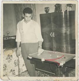 A man with a small pool table