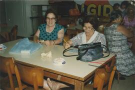 Elderly women, including Guza, playing bingo