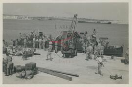 Military personnel unloading a boat at Kalafrana