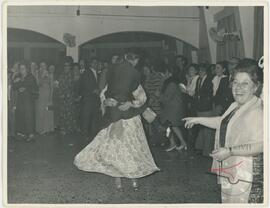 A couple dancing while others watch them at an event