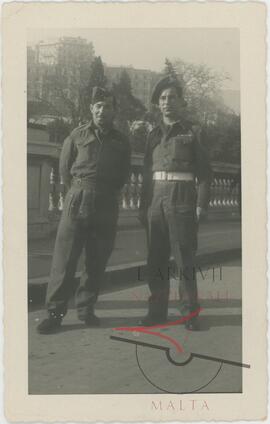 Two men wearing RMAA uniforms, somewhere abroad