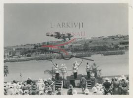 RAF planes fly over military personnel in parade during King George IV's birthday celebrations at Marsa