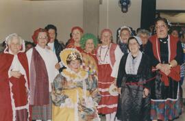 Elderly women dressed in costumes for a party, possibly including Gruppetta's mother