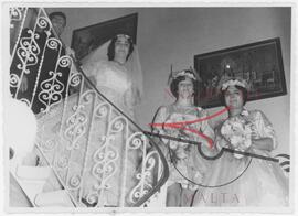 Bride poses with bridesmaids on a staircase