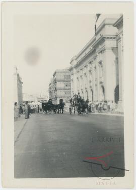 Horse-drawn carts during a funeral procession