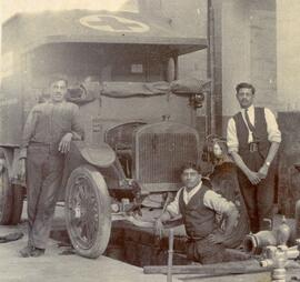 Three men and a GMC Military (Red Cross) motor ambulance