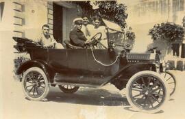 An unknown motor car with four people