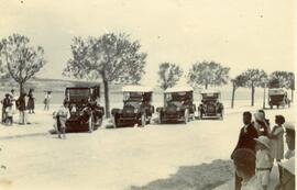 A line-up of four motor-cars with a fifth travelling away