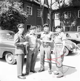 A Maltese Chaplin and  soldiers posing for a photograph