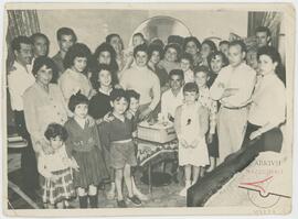 Family gathered around a tape player