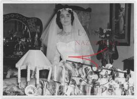 A bride poses with the gifts received on her wedding day