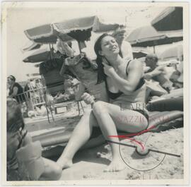 Woman brushing her hair at the beach