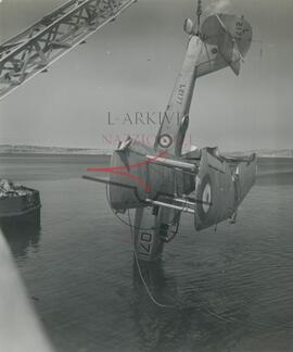 British military plane Walrus being hoisted out of the sea