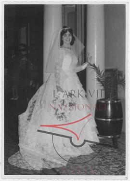 A bride poses for a photo on her wedding day