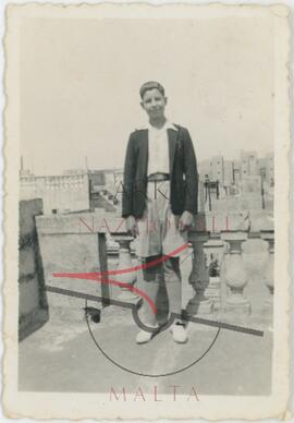 A boy posing for a picture on a rooftop