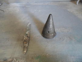 A wartime shell cap belonging to Ċensinu next to a table knife