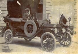 Motor car 12 and a black horse