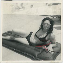 Woman posing for a photo at the beach