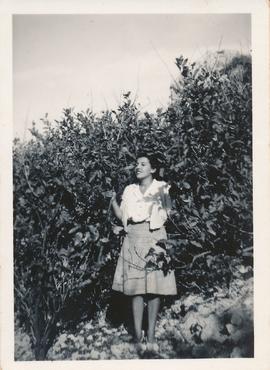 Loulou Pizzuto standing among citrus trees