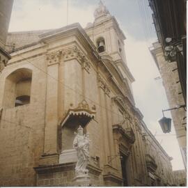 A statue next to a church