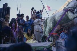 Carnival with people on float wearing costumes