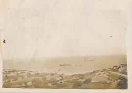 A rural area in Malta with Royal Navy ships in the background