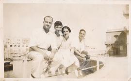 Four people posing for a photograph at Spinola Bay