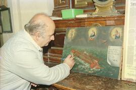 Mr Zammit touching up a painting from the time of the Knights of St John