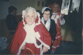 Elderly women dressed in costumes for a party, possibly including Gruppetta's mother