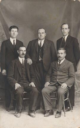 Postcard showing five men posing